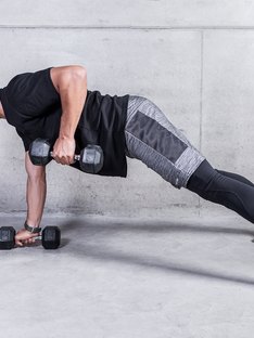 Man doing a renegade row exercise with dumbbells during an upper body workout