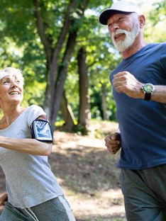 Older woman and man running outside