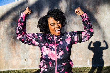 Woman flexing after 20-minute morning workout