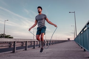 Man doing a 20-minute jump rope workout outside