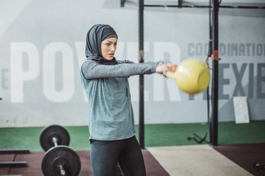 woman doing a deadlift, one of the best exercises for women to get lean