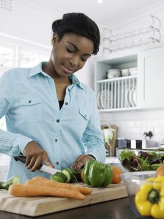 Woman chopping vegetables for healthy recipes
