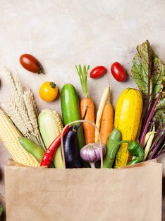 healthy autumn vegetables in paper grocery bag
